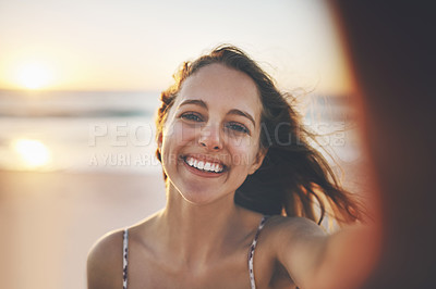 Buy stock photo Cropped shot of a young woman enjoying her day at the beach