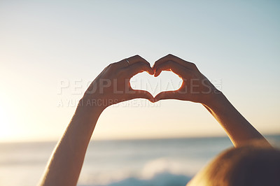 Buy stock photo Cropped shot of a woman making a heart shape with her hands