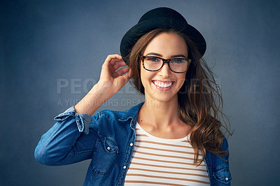 Buy stock photo Portrait of a quirky young woman smiling against a gray background in studio