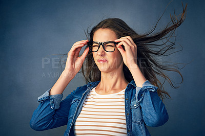 Buy stock photo Surprise, woman and glasses with wind in studio for hair blow, crazy weather and comedy for good news as winner. Shocked, female geek with eyewear for lottery giveaway, wow and blue background