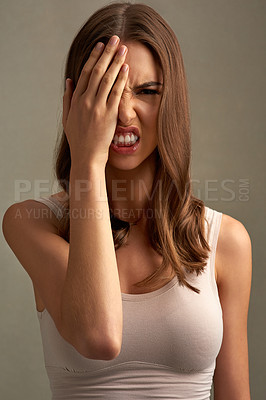 Buy stock photo Shout, cover face and portrait of woman in studio with anger, upset and mad reaction. Body language, facial expression and isolated person with hands on eye for stress, unhappy or emoji on background