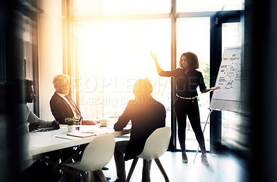 Buy stock photo Shot of a young businesswoman giving a presentation to colleagues in a boardroom