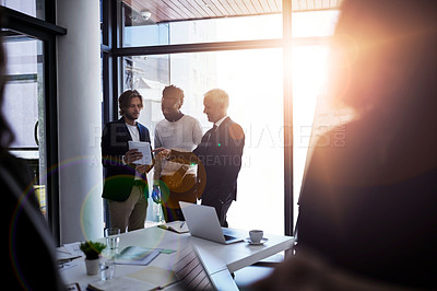 Buy stock photo Shot of a group of business colleagues talking together during a meeting in a boardroom