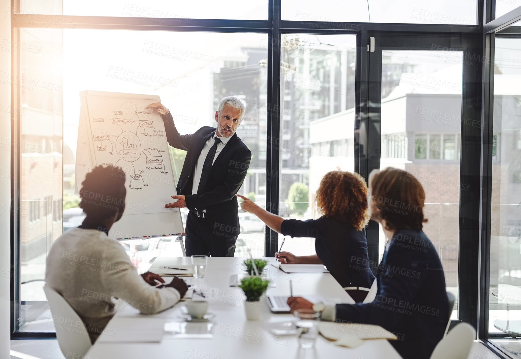 Buy stock photo Cropped shot of a businessman giving a presentation to his colleagues in a boardroom