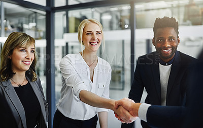 Buy stock photo Cropped shot of businesspeople shaking hands in an office