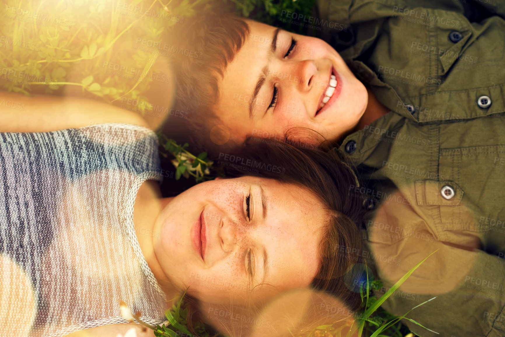 Buy stock photo Children, lying and relax on grass in park, garden and countryside outdoor in weekend holiday. Siblings, boy and girl with smile, happiness and bonding together in nature as brother and sister