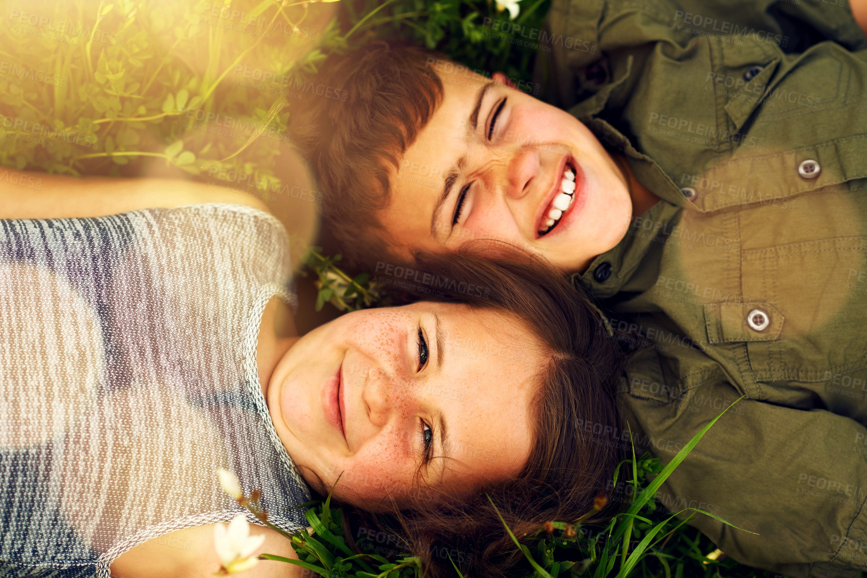 Buy stock photo Children, portrait and relax on grass in park, garden and countryside outdoor on weekend holiday. Siblings, boy and girl with smile, happiness and bonding together while lying in backyard or nature