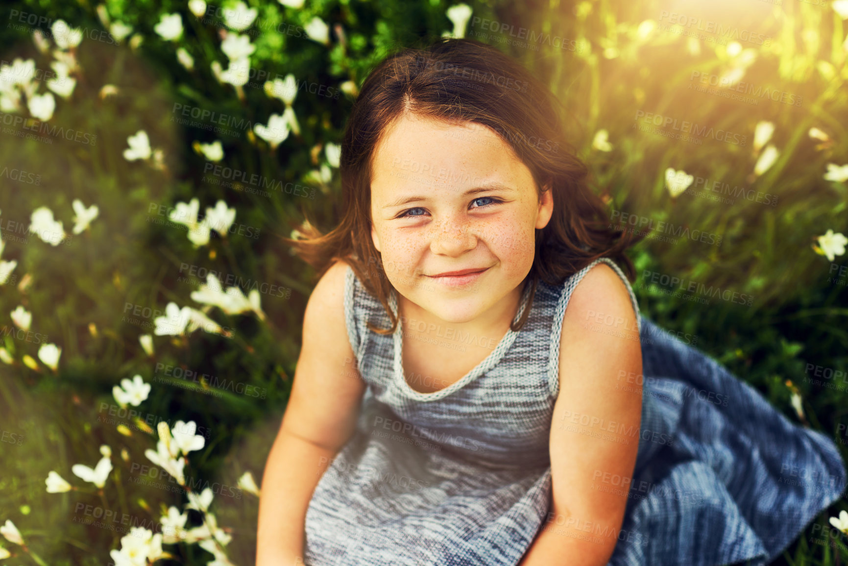 Buy stock photo Nature, grass and child in portrait for relaxing, resting and enjoying outdoor in park. Backyard, garden and flowers countryside with happy girl on vacation, summer break and freedom with smile