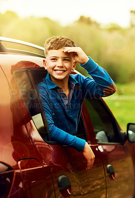 Buy stock photo Portrait of an adorable little boy leaning out of a car window outside