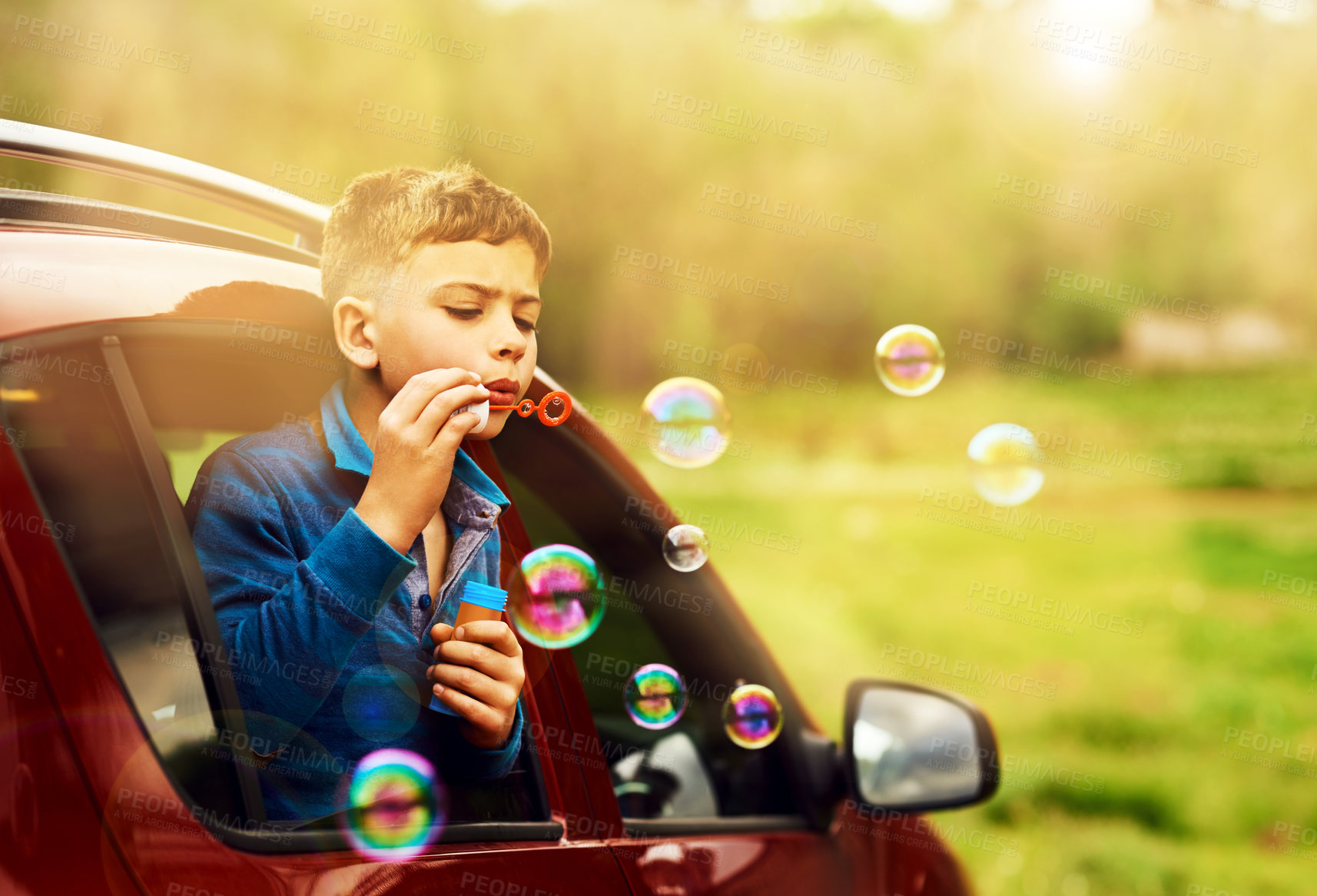 Buy stock photo Blowing, bubbles and child for fun by window in nature, outdoor or countryside in Australia. Kid, boy and game in car for playing, freedom and childhood development of kid learning with soap toys