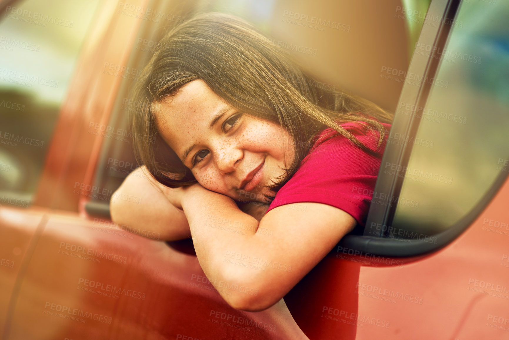 Buy stock photo Portrait of an adorable little girl leaning out of a car window outside