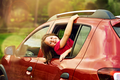 Buy stock photo Portrait of an adorable little girl leaning out of a car window outside