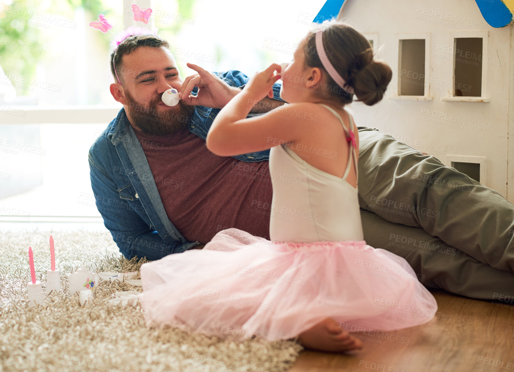 Buy stock photo Happy, father and daughter at tea party or picnic in home with joyful, drinking and toys for bonding. Male parent, child and fun as family in playroom for memory or childhood development in apartment