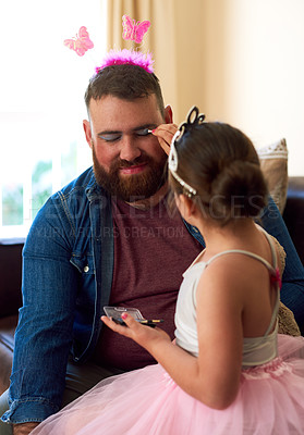 Buy stock photo Shot of an adorable little girl putting makeup on her father at home