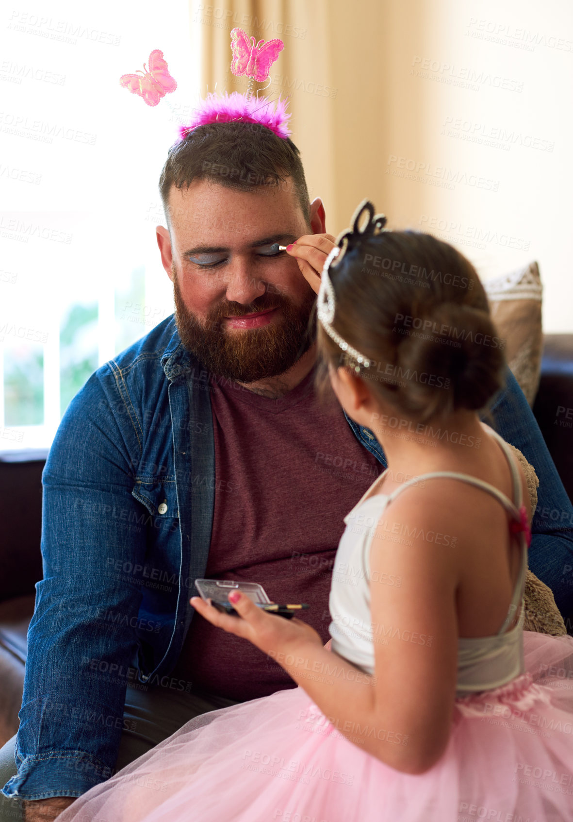 Buy stock photo Shot of an adorable little girl putting makeup on her father at home