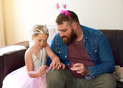 Buy stock photo Shot of an adorable little girl painting her father’s nails at home