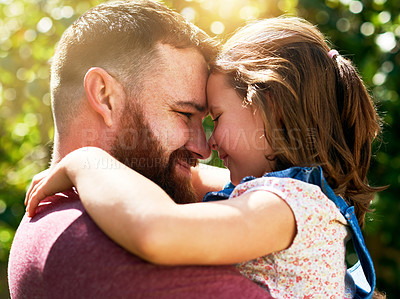 Buy stock photo Shot of an adorable little girl sharing an affectionate moment with her father outdoors