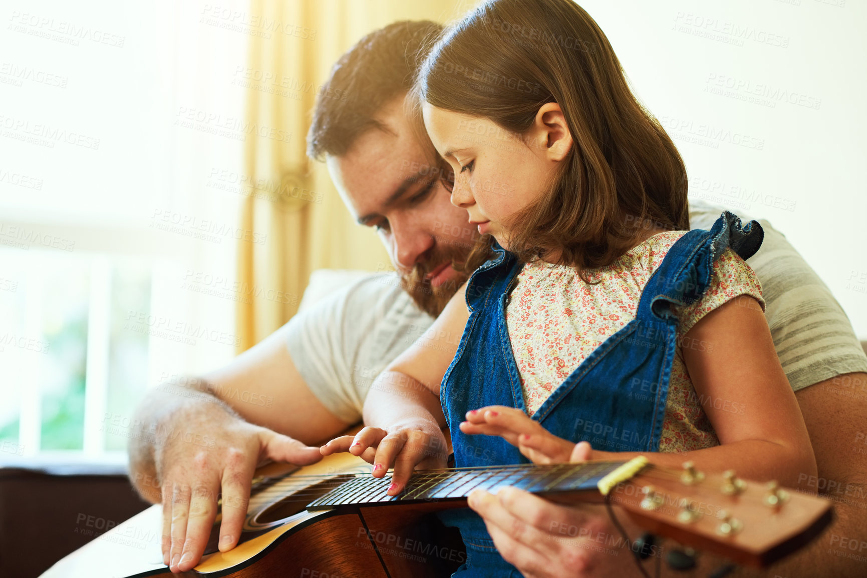 Buy stock photo Father, home and child with guitar on sofa, learning music and family bonding or teaching instrument in house. Weekend, childhood development and creative for knowledge, girl and playing together