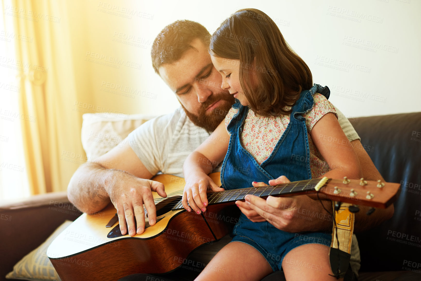 Buy stock photo Father, home and child with guitar on sofa, learning music and family bonding or teaching instrument in house. Weekend, childhood development and creative for knowledge, growth and playing together