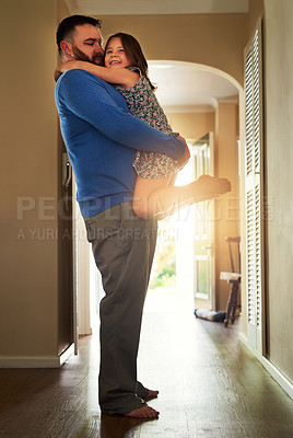 Buy stock photo Shot of an adorable little hugging her father at home