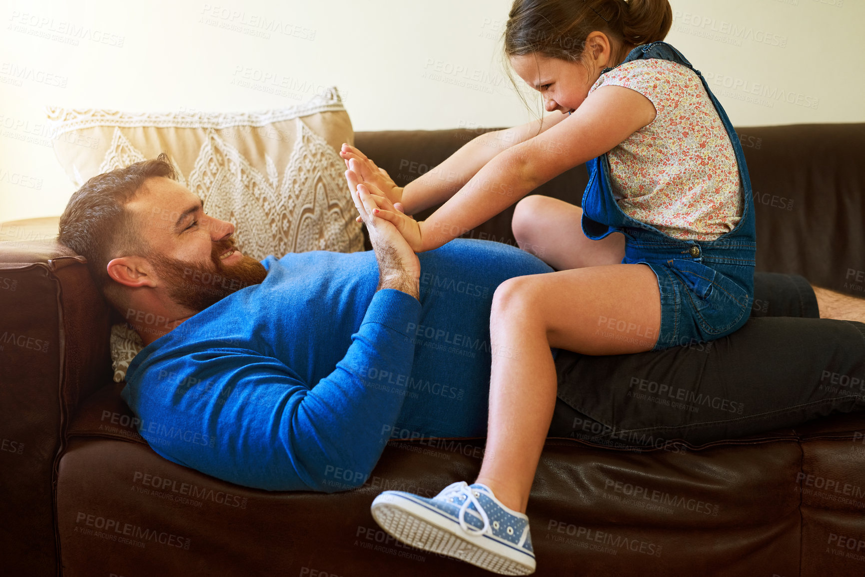 Buy stock photo Playing, relax and father with child on sofa in home for bonding, laugh and smile together on weekend. Family, parenting and dad with girl for hand game, fun and trust in living room on holiday