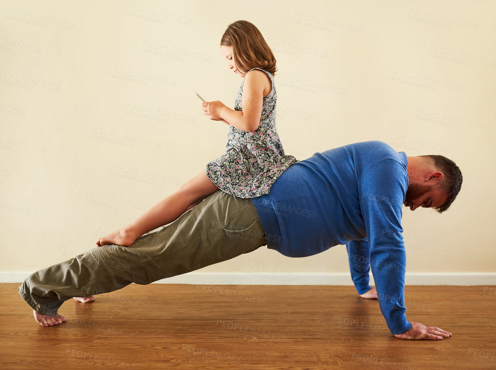 Buy stock photo Dad, child and push ups on back in home for exercise, workout and endurance for wellness in house. Daughter, phone and father with plank for strength training, core muscles and bonding with fitness