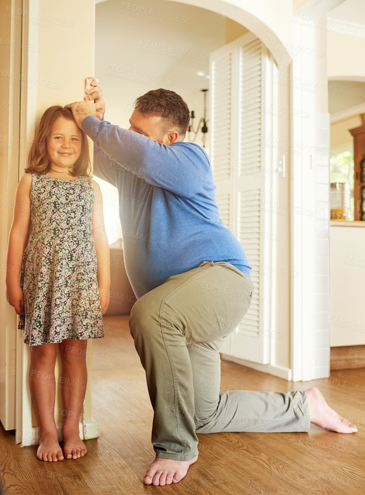 Buy stock photo Father, girl and measure on wall in home for growth, healthy development and smile for height increase. People, dad and happy daughter with pride for growing progress, childhood memories or parenting