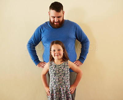 Buy stock photo Father, girl and portrait in home or happy for bonding, relax and confidence with mockup space. Family, dad and daughter with smile by wall for relationship, parenting and childhood with height check