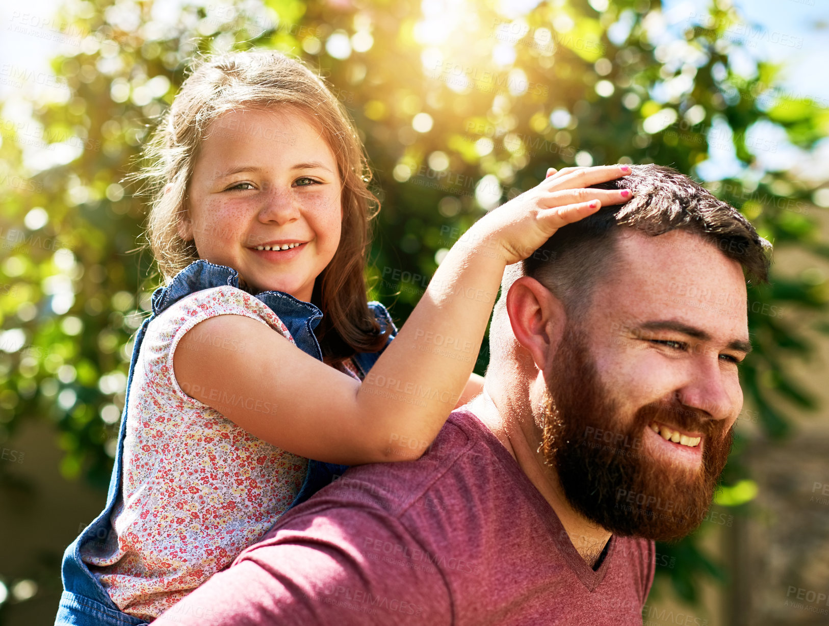 Buy stock photo Shot of an adorable little girl enjoying a piggyback ride from her father in their backyard