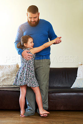 Buy stock photo Shot of an adorable little girl dancing with her father at home