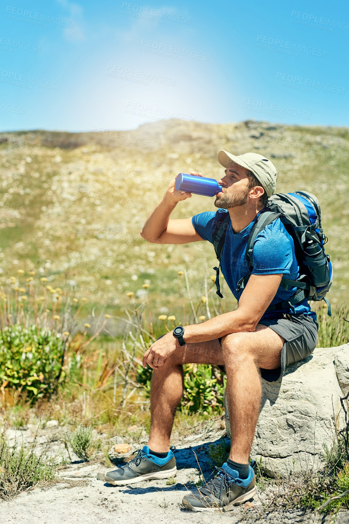 Buy stock photo Shot of a young man taking a break while out on a hike