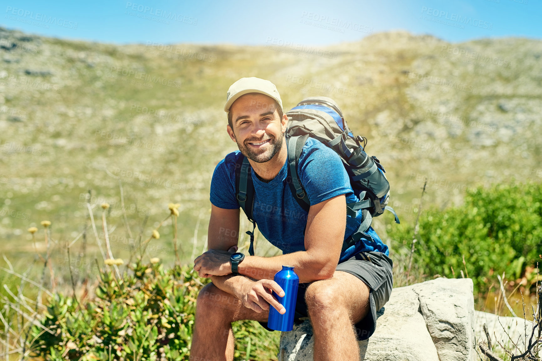 Buy stock photo Portrait of a young man taking a break while out on a hike