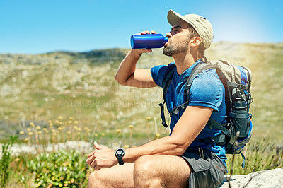 Buy stock photo Cropped shot of a young man taking a break while out on a hike