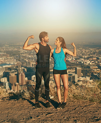 Buy stock photo Shot of a young couple flexing their muscles while out for a workout