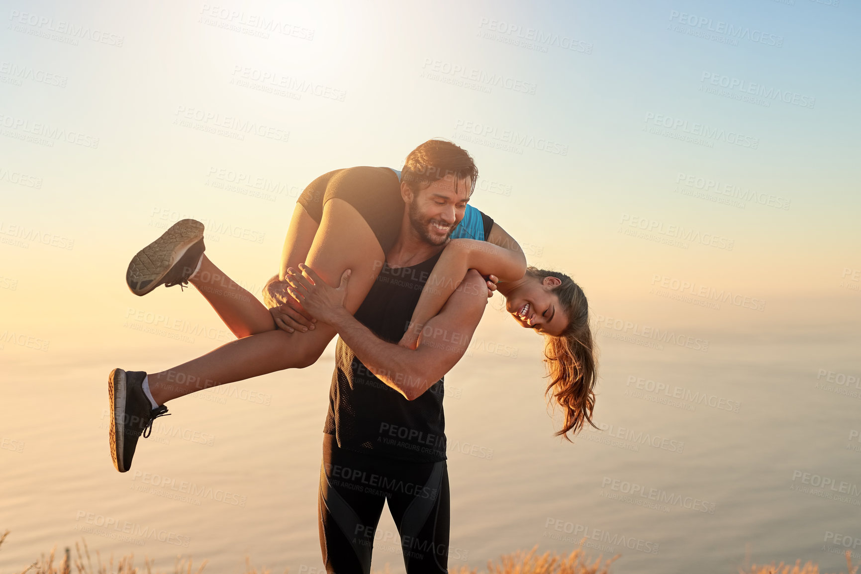 Buy stock photo Shot of a sporty couple being playful while out for a workout