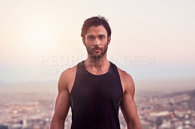 Buy stock photo Cropped shot of a sporty young man against a city background