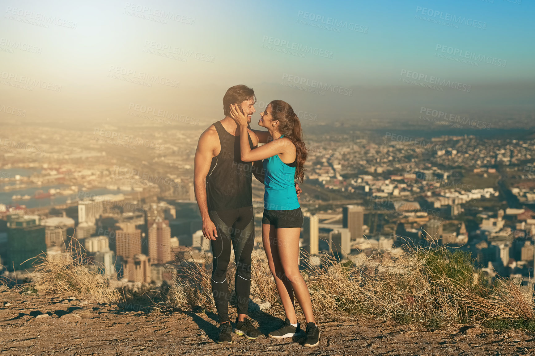 Buy stock photo Fitness, couple and love on mountain outdoor with city view, exercise and workout together for healthcare or affection. Man, woman and bonding with adventure in summer for hiking, nature and cardio.