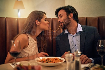 Buy stock photo Love, pasta and happy with couple in restaurant sharing for romance, valentines day and date. Bonding, smile and celebration with man and woman with spaghetti at table for fine dining, wine and cute