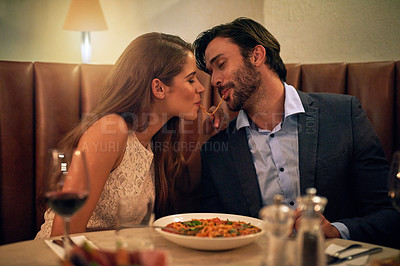Buy stock photo Love, share and food with couple in restaurant for romance, valentines day and date. Bonding, smile and celebration with man and woman with spaghetti pasta at table for fine dining, wine and cute