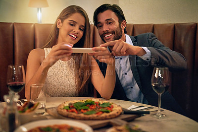 Buy stock photo Restaurant, couple and phone for photo of food, pizza or romantic date night meal for valentines day. Social media, picture and influencer man with woman on smartphone for blog, review or eating post