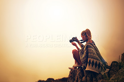 Buy stock photo Shot of a young photographer taking a picture of a foggy landscape from the top of a mountain