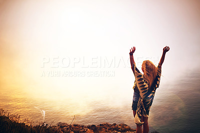 Buy stock photo Shot of a happy young woman admiring a foggy view from the top of a mountain