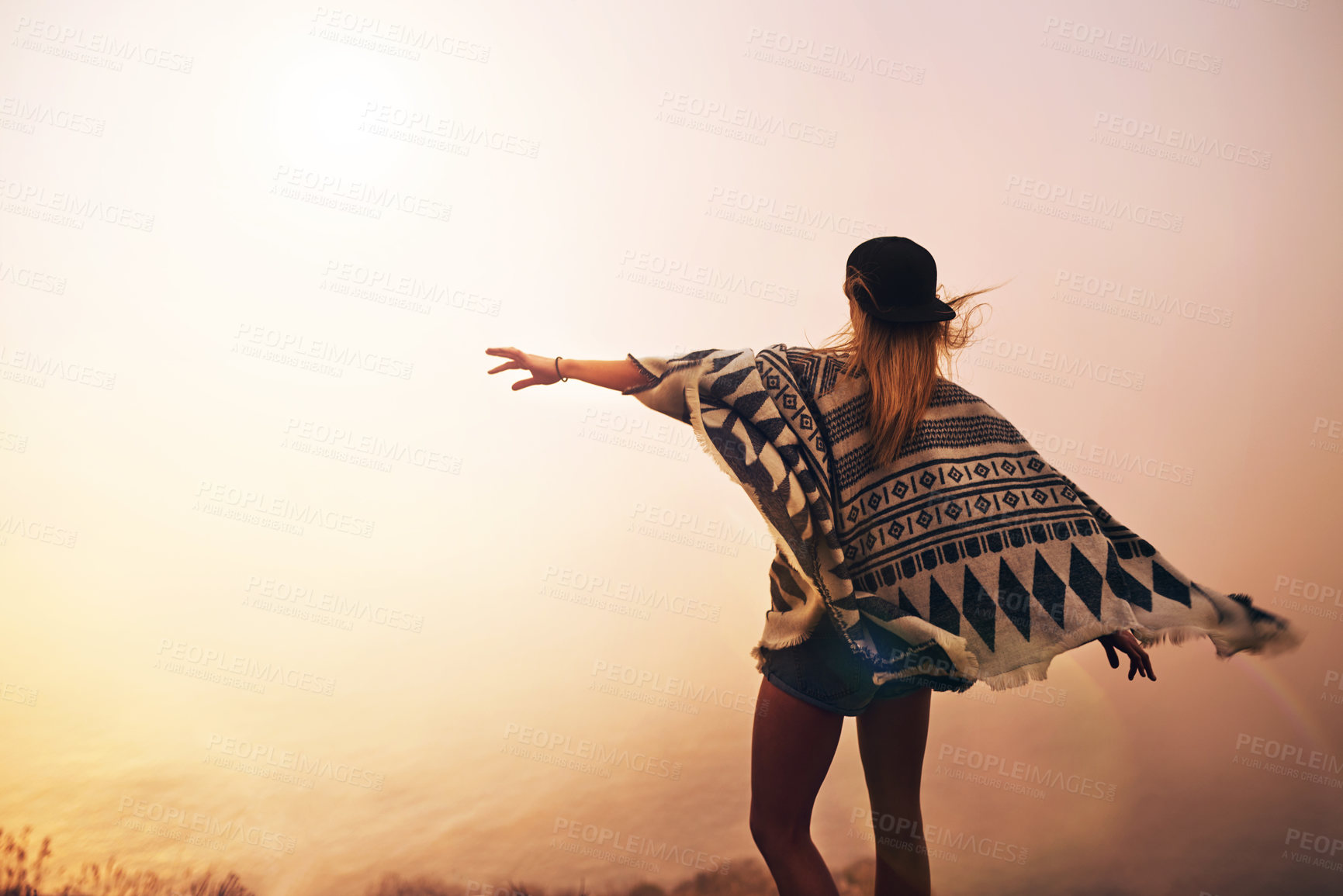 Buy stock photo Shot of a happy young woman admiring a foggy view from the top of a mountain