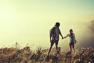 Buy stock photo Shot of an affectionate young couple bonding while out on a hike together