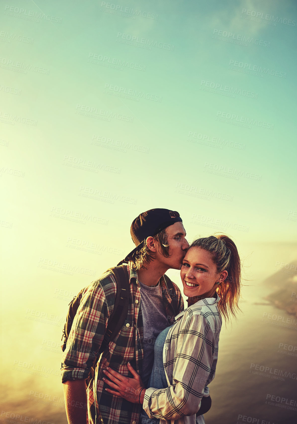 Buy stock photo Shot of an affectionate young couple bonding while out on a hike together