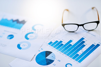 Buy stock photo Shot of business documentation and glasses on an office desk