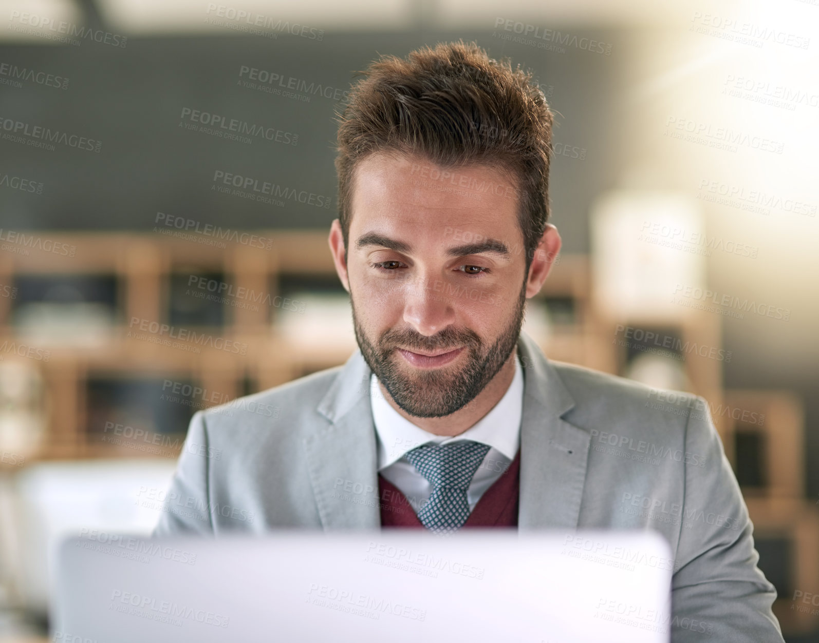 Buy stock photo Shot of a businessman using a laptop at his office desk