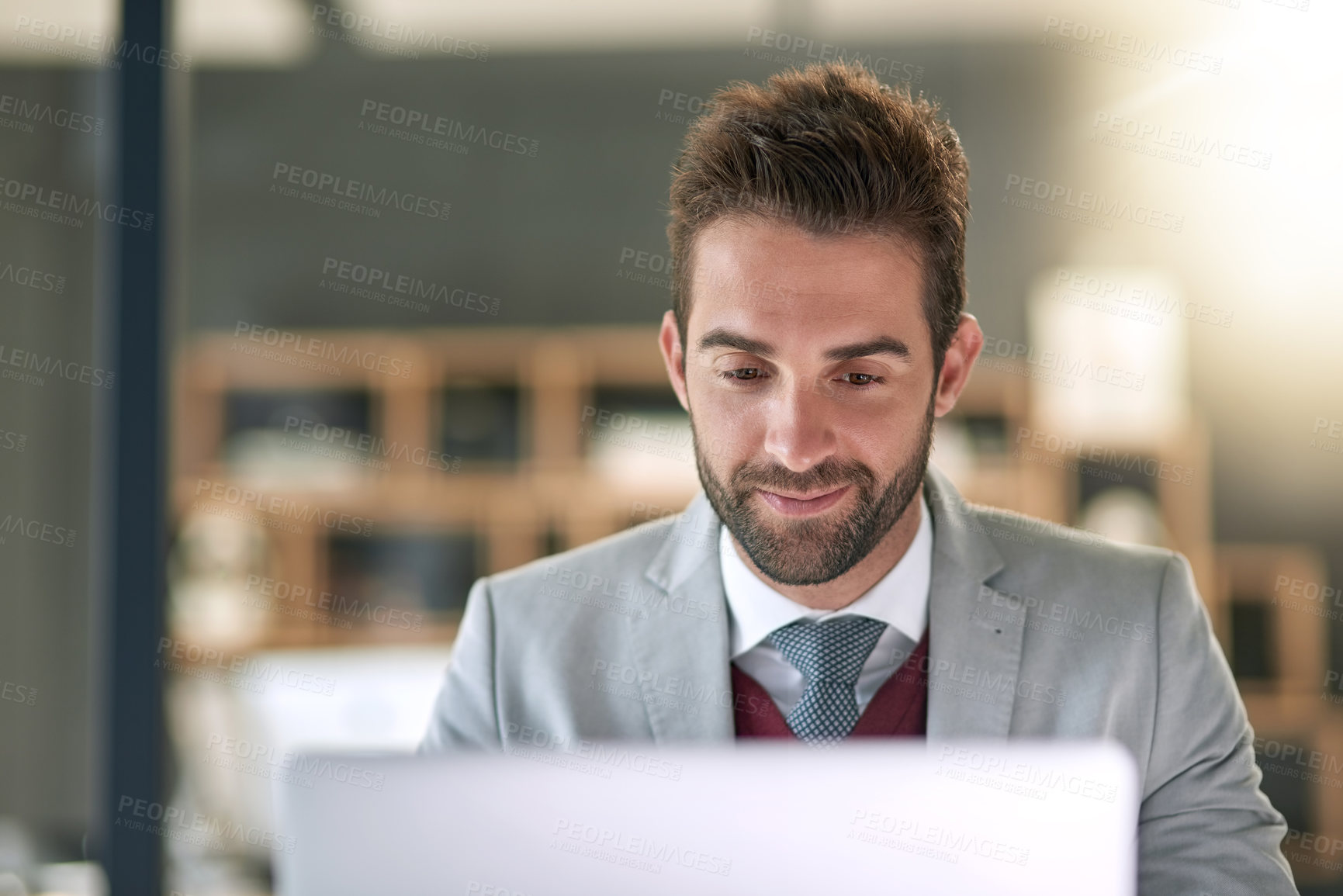 Buy stock photo Shot of a businessman using a laptop at his office desk