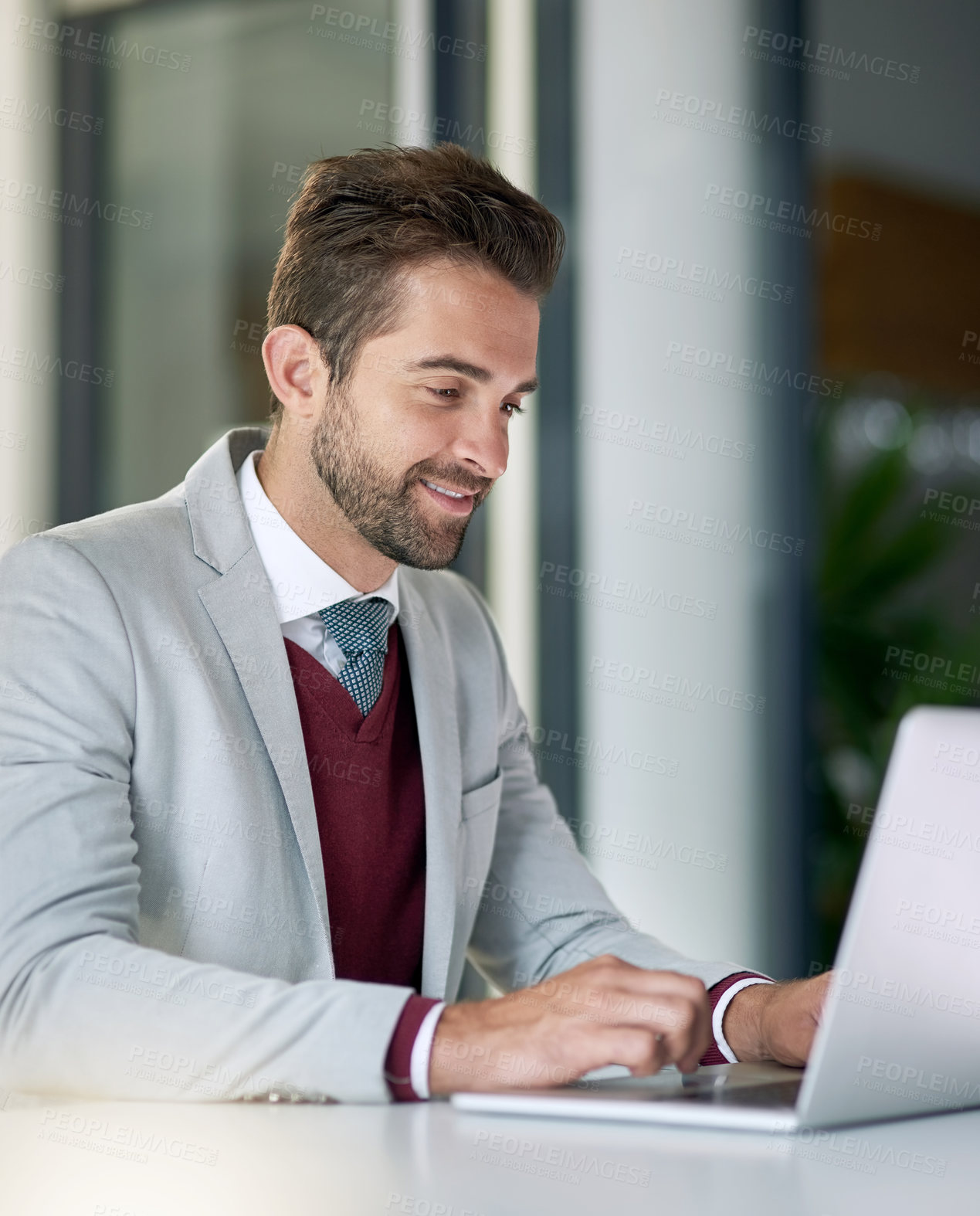 Buy stock photo Shot of a businessman using a laptop at his office desk