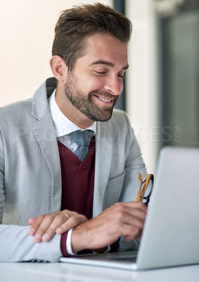 Buy stock photo Shot of a businessman using a laptop at his office desk